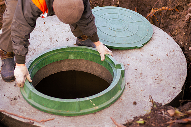Technician cleaning a residential septic tank in Ocala, FL
