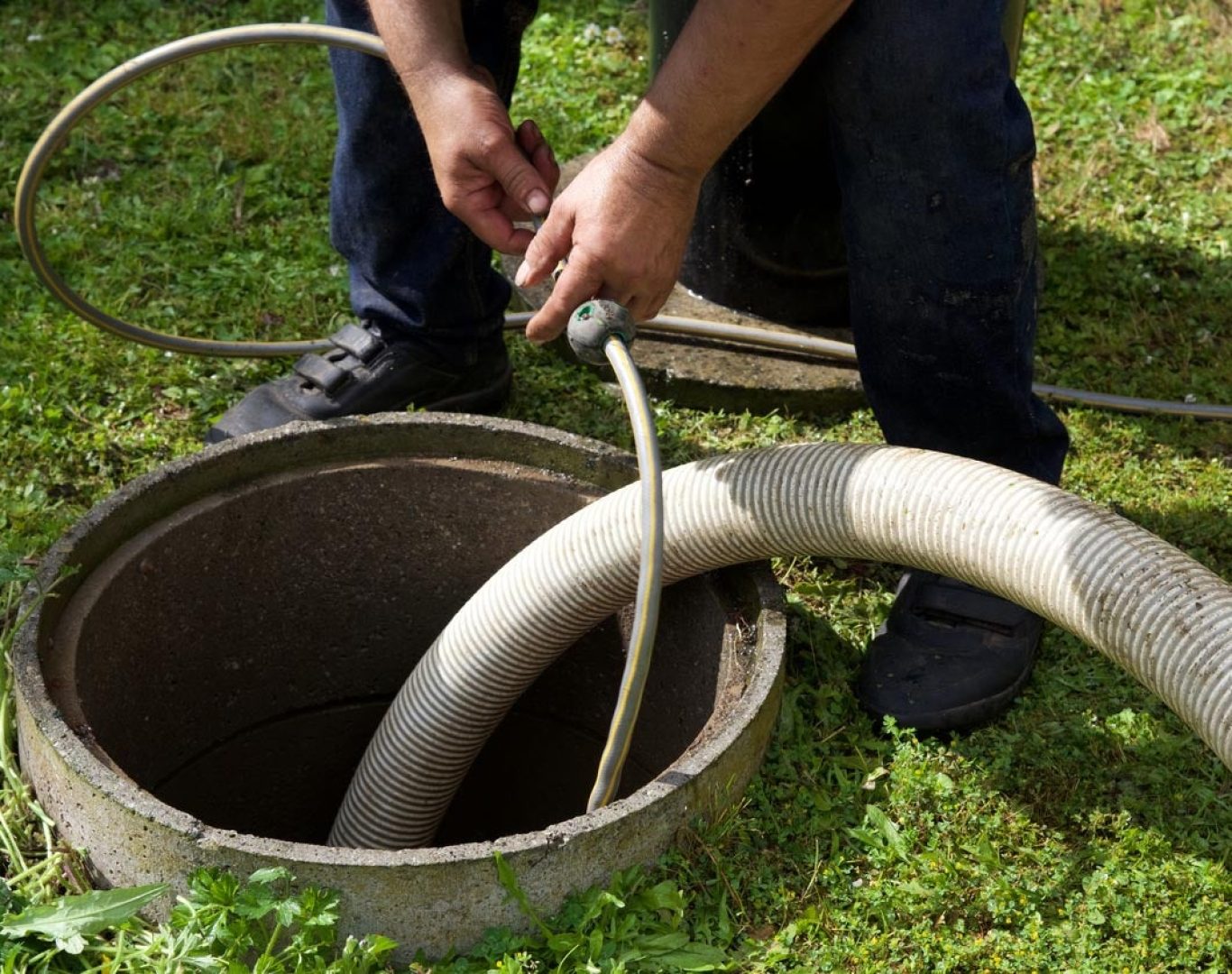Technician cleaning a residential septic tank in Ocala, FL