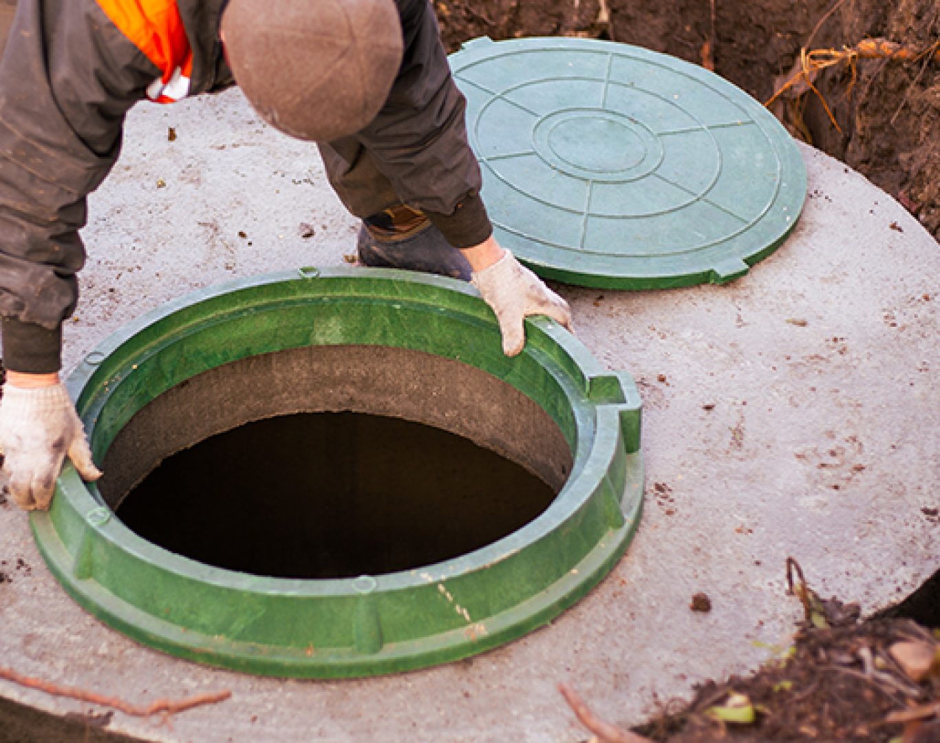 Technician cleaning a residential septic tank in Ocala, FL